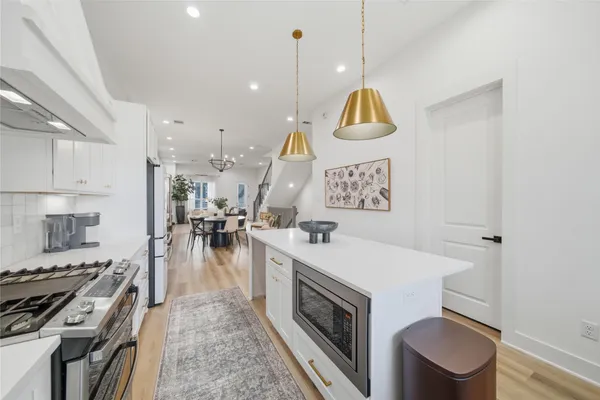 a kitchen with a stove a sink and a refrigerator