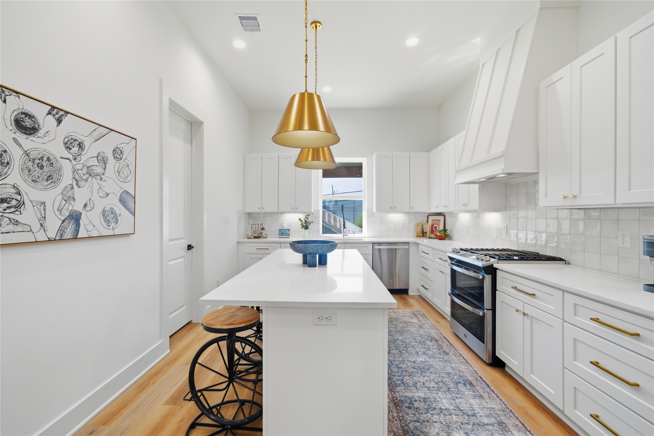 1307 East 27th Street Houston, TX 77009 - Photo 8 of 33 a kitchen with stainless steel appliances granite countertop a sink a stove a refrigerator and cabinets