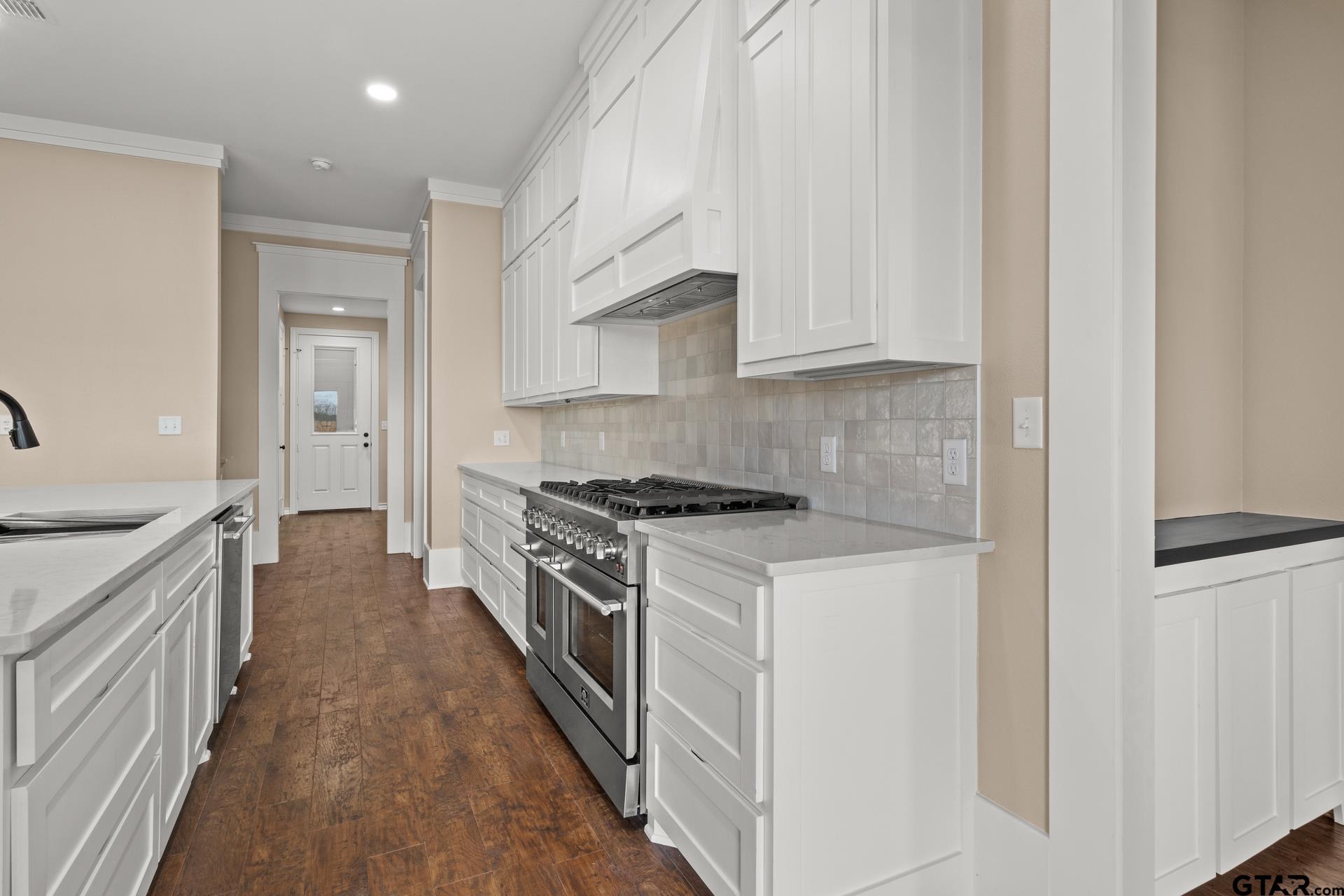 1003 Stone Haven Mount Pleasant, TX 75455 - Photo 11 of 41 a kitchen with a stove top oven sink and cabinets