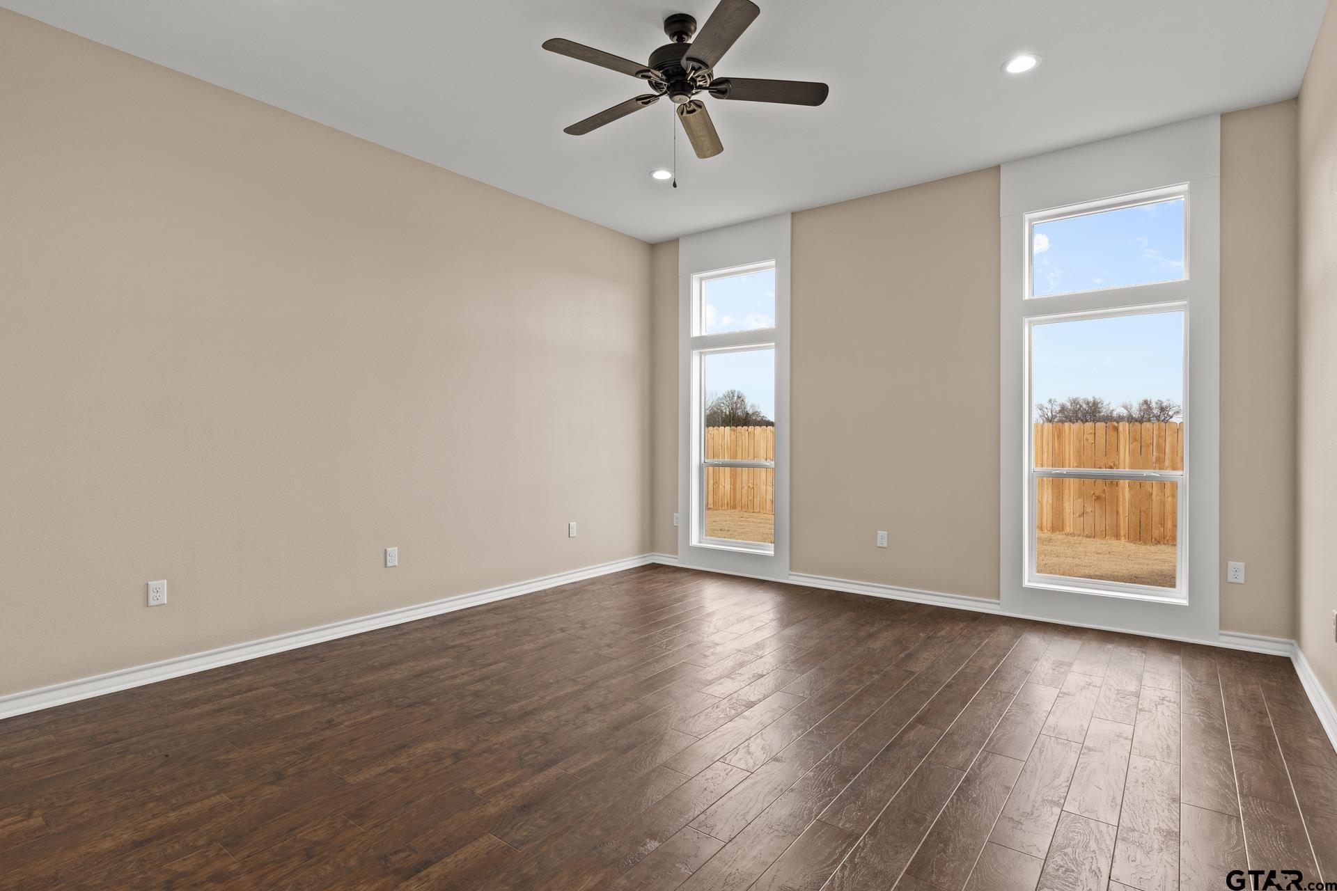 1003 Stone Haven Mount Pleasant, TX 75455 - Photo 12 of 41 an empty room with wooden floor fan and windows