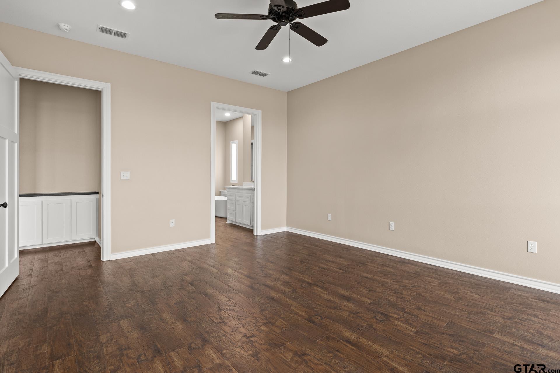 1003 Stone Haven Mount Pleasant, TX 75455 - Photo 14 of 41 a view of an empty room with wooden floor and a ceiling fan