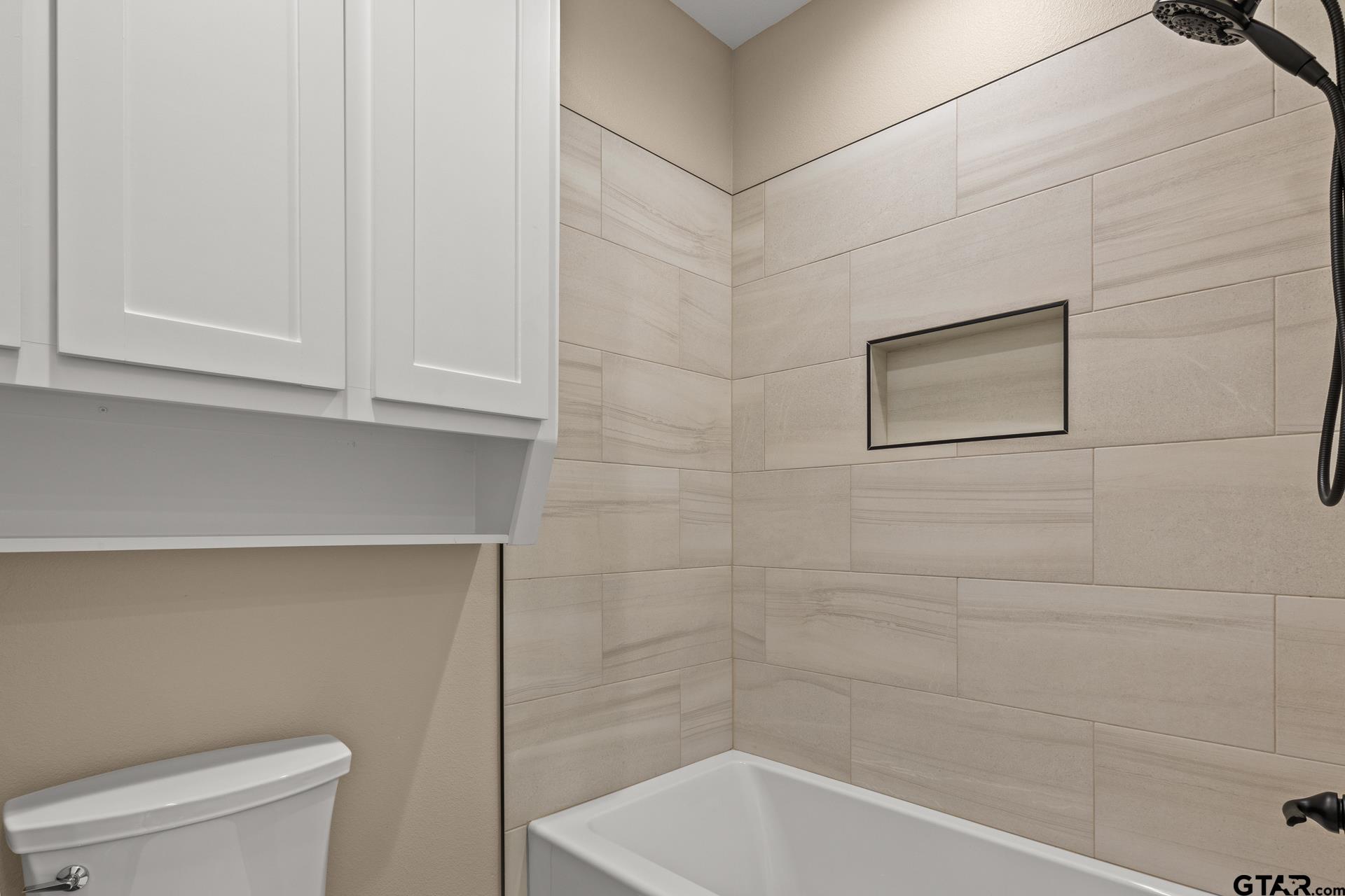 1003 Stone Haven Mount Pleasant, TX 75455 - Photo 23 of 41 a bathroom with a bathtub and a toilet