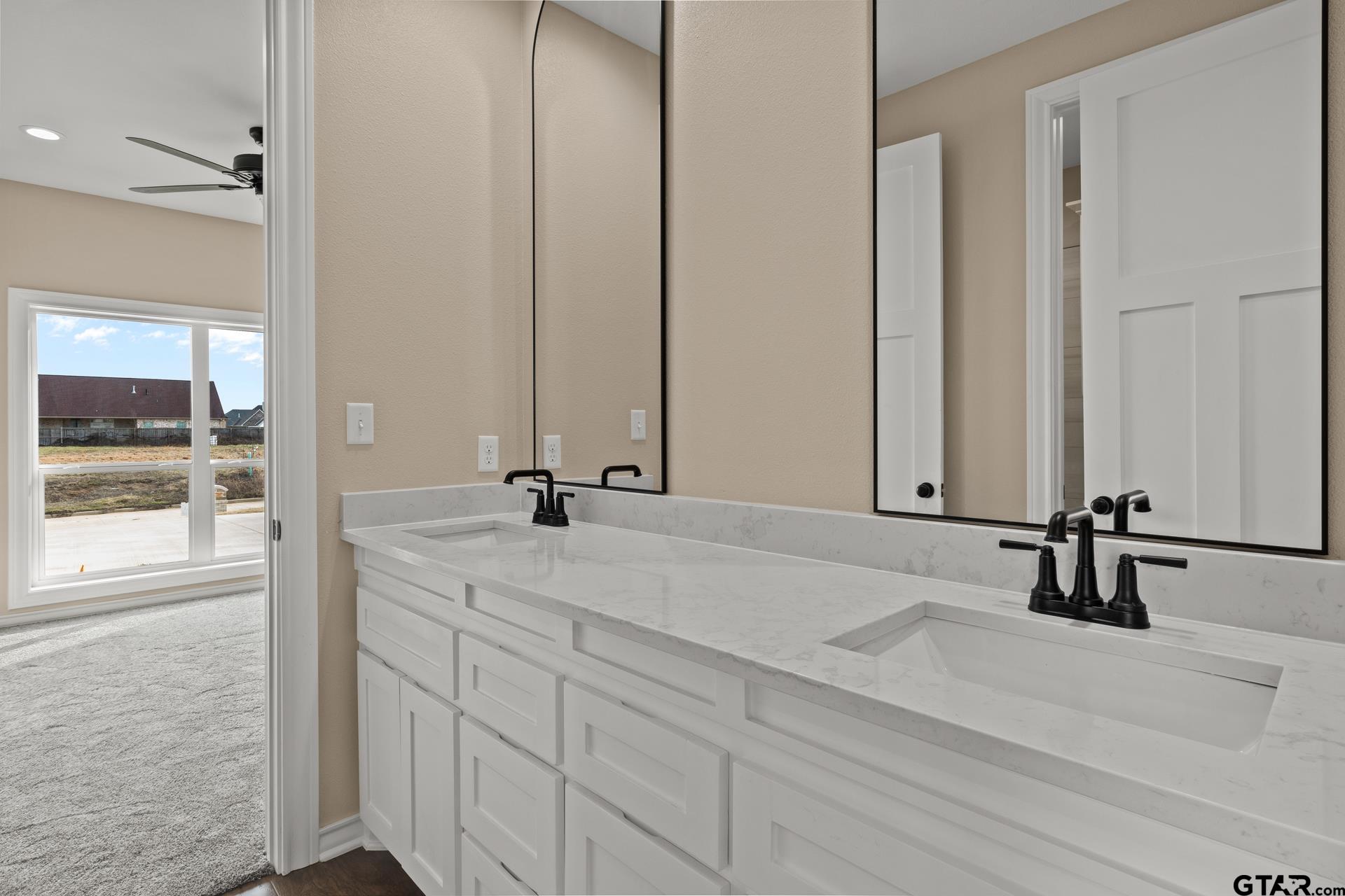 1003 Stone Haven Mount Pleasant, TX 75455 - Photo 24 of 41 a bathroom with a double vanity sink and mirror