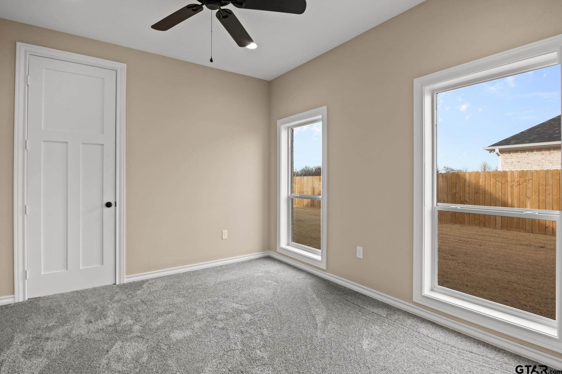 1003 Stone Haven Mount Pleasant, TX 75455 - Photo 25 of 41 an empty room with fan and windows