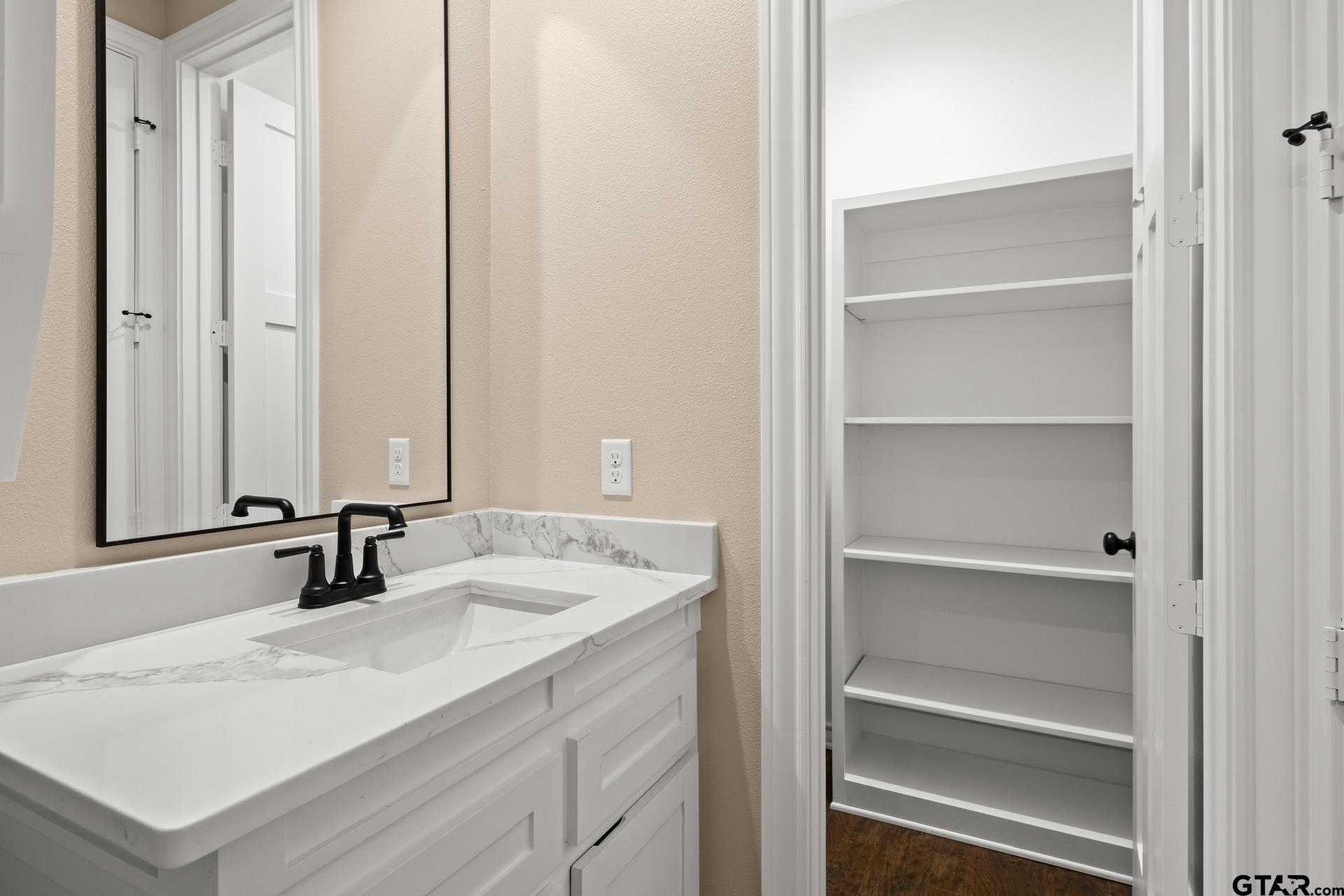 1003 Stone Haven Mount Pleasant, TX 75455 - Photo 29 of 41 a bathroom with a sink and a mirror