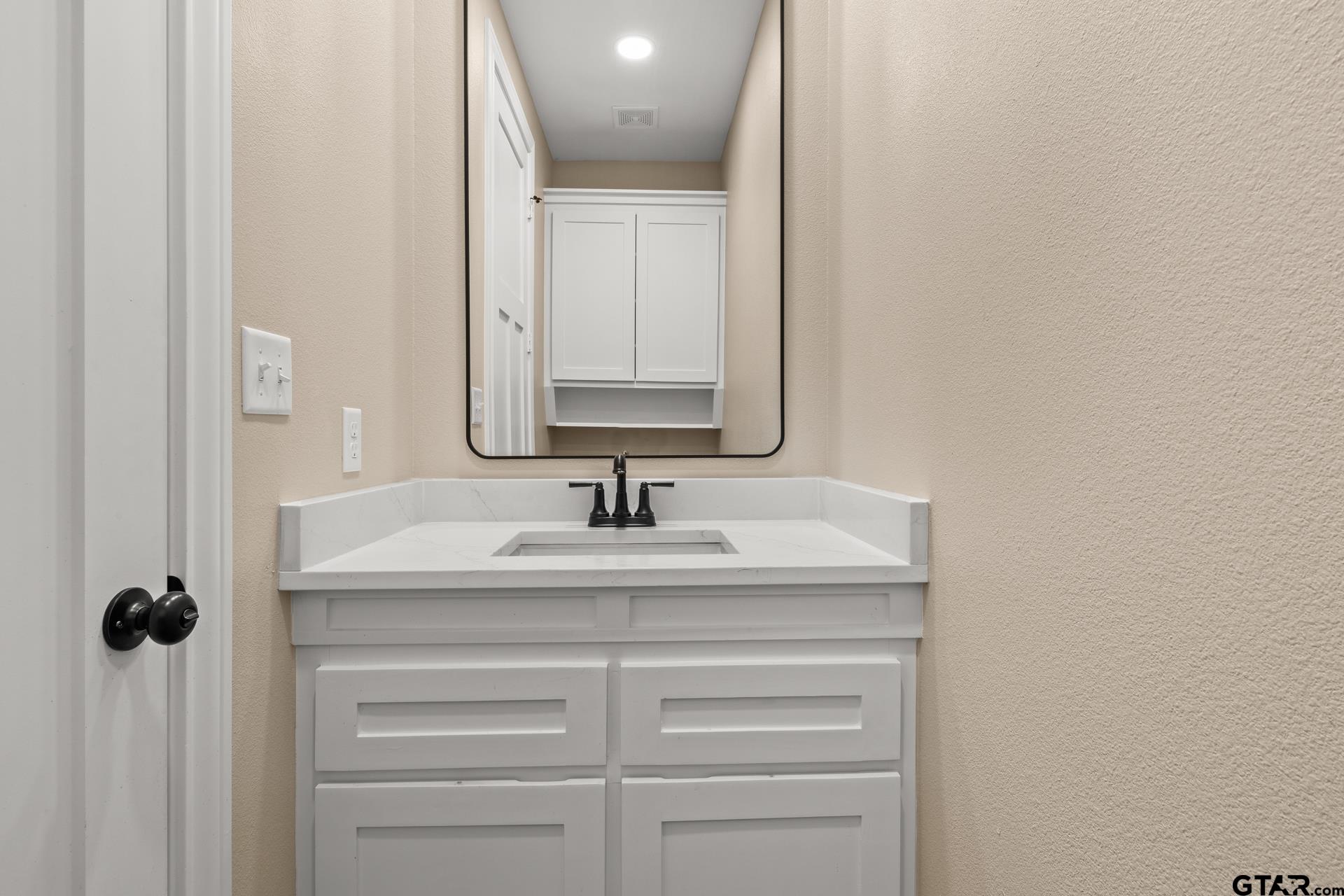 1003 Stone Haven Mount Pleasant, TX 75455 - Photo 32 of 41 a bathroom with a sink vanity and a mirror