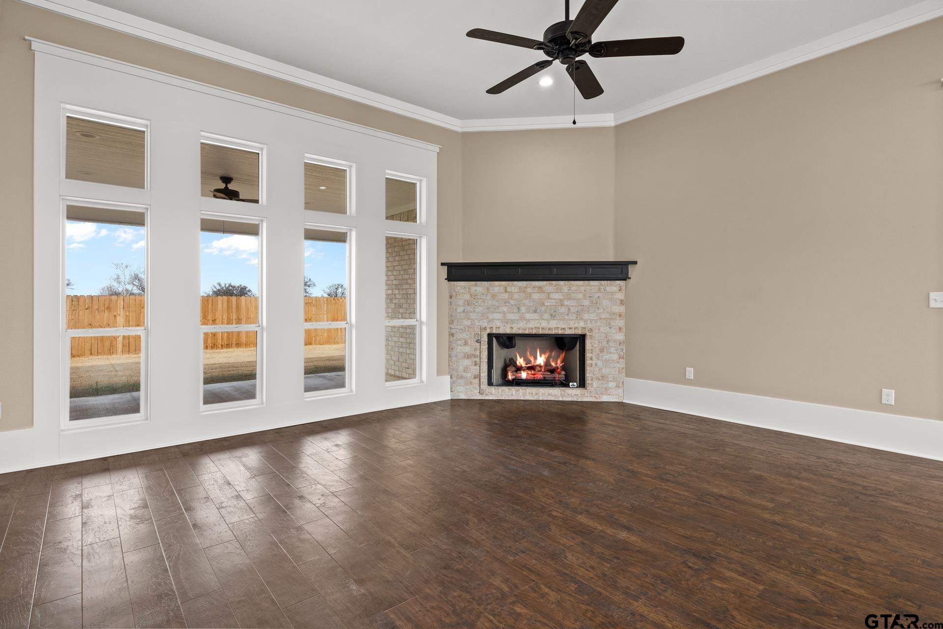 1003 Stone Haven Mount Pleasant, TX 75455 - Photo 6 of 41 a view of an empty room with wooden floor and a window