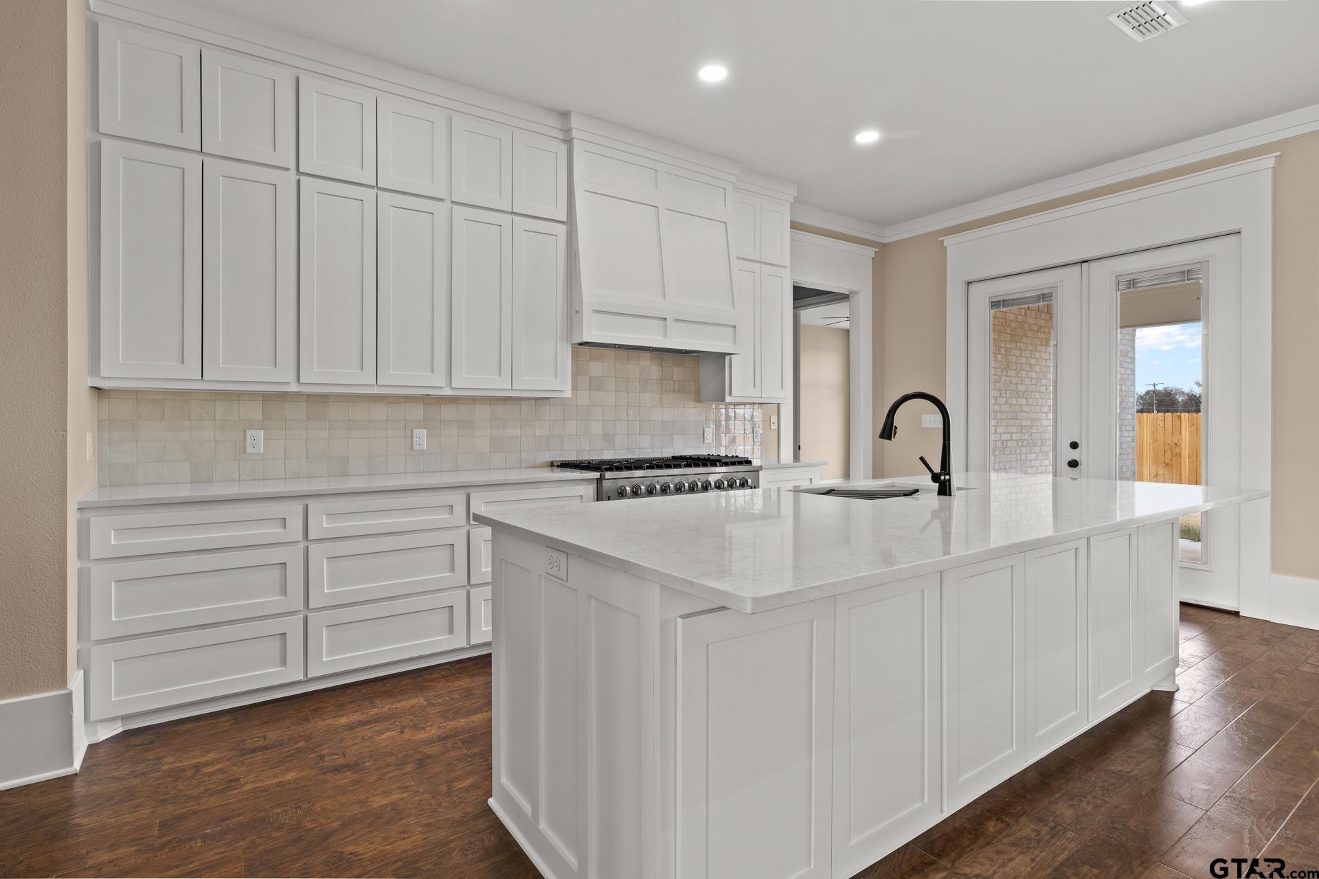 1003 Stone Haven Mount Pleasant, TX 75455 - Photo 8 of 41 a kitchen with white cabinets and sink