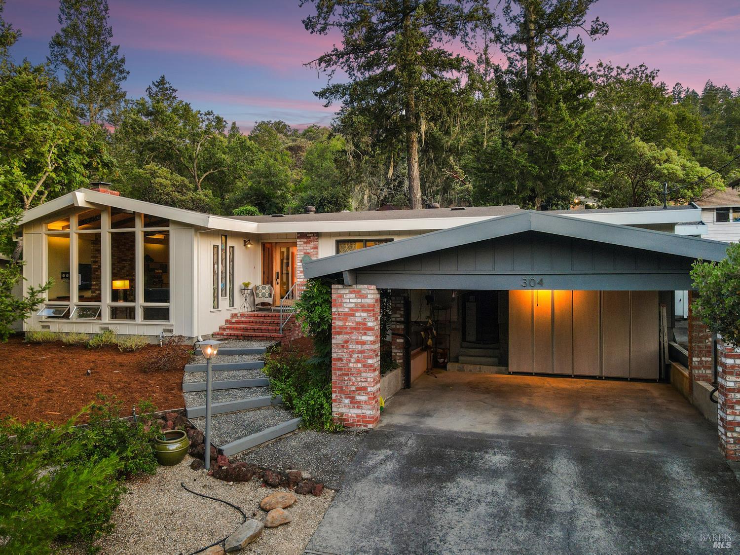 a view of a house with a porch and a yard