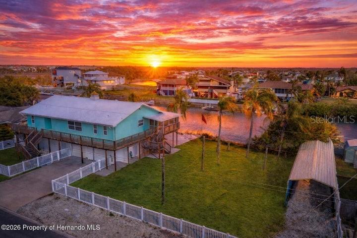 3416 Crape Myrtle Drive Hernando Beach, FL 34607 - Photo 1 of 1 a view of a lake in front of residential houses