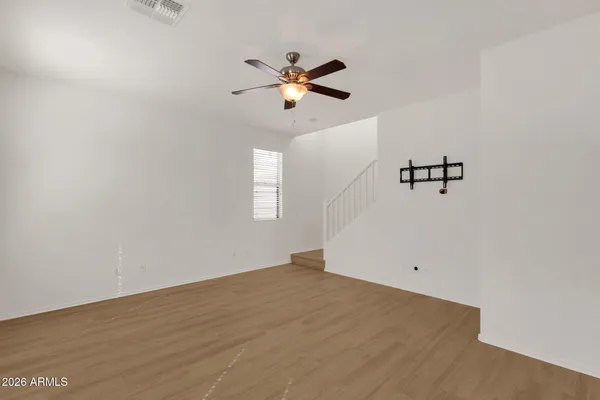 a view of a room with window and ceiling fan