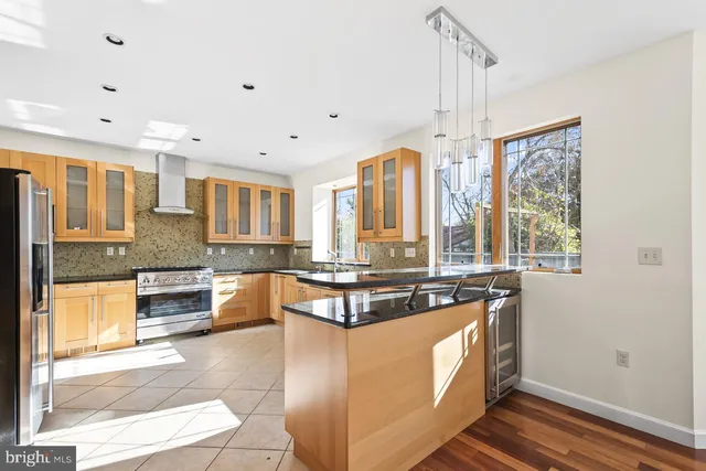 a kitchen with stainless steel appliances granite countertop a stove sink and cabinets