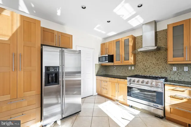 a kitchen with stainless steel appliances a refrigerator and a sink