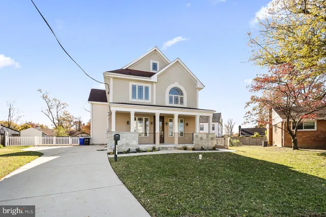 a front view of a house with a yard table and chairs