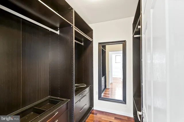 a bathroom with a granite countertop tub sink and mirror