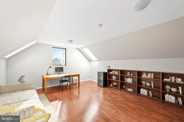 a living room with furniture and a baby crib