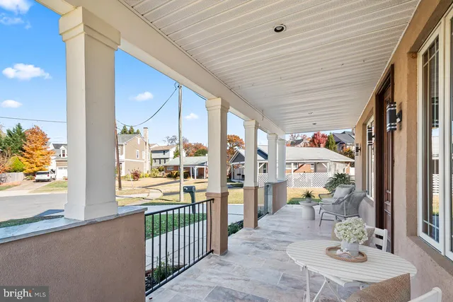 a view of a balcony dining table chairs and chandelier