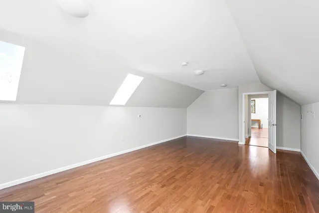 a bathroom with a shower and a glass door