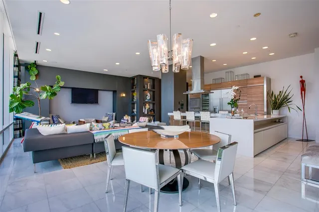 a view of a dining room with furniture and a chandelier