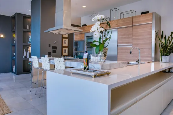 a large white kitchen with a table and chairs