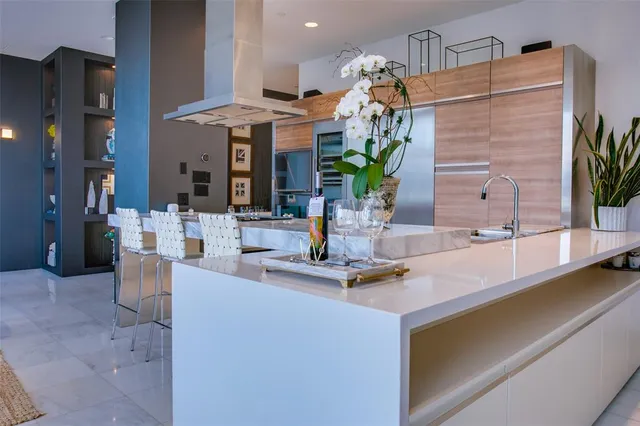 a large white kitchen with a table and chairs