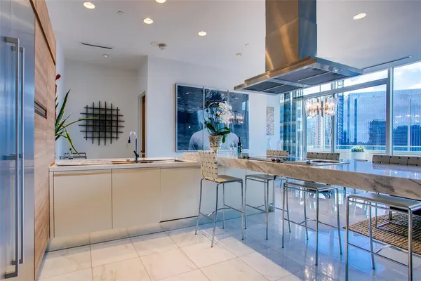 a large kitchen with a large counter top space appliances and cabinets