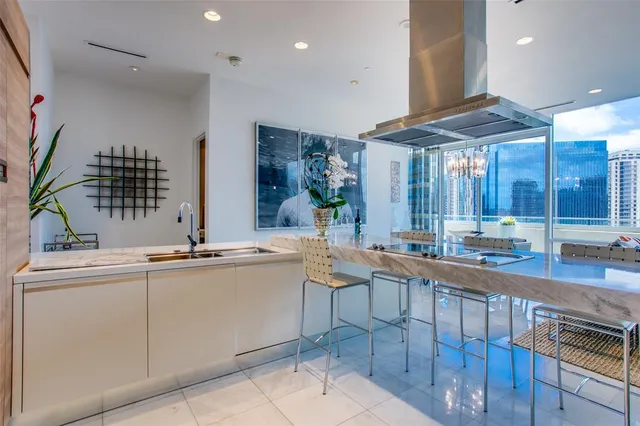 a living room with furniture and kitchen view
