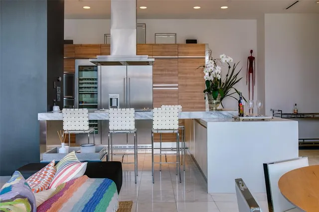 a kitchen with kitchen island granite countertop a table and chairs in it