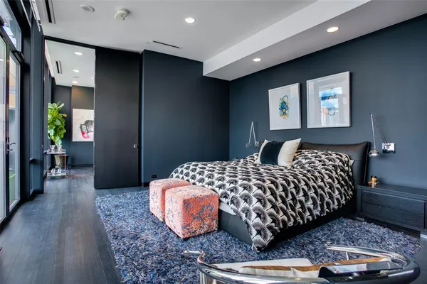 a bedroom with a large bed and a flat screen tv