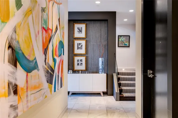 a view of entryway and hall with wooden floor