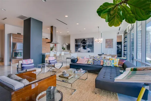 a living room with furniture and a potted plant