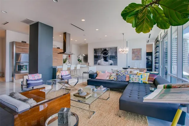 a living room with furniture and a potted plant