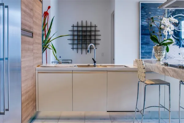 a close view of dining table chair and a potted plant