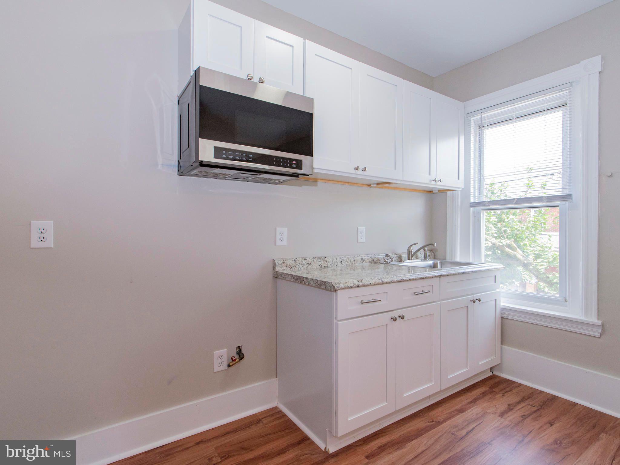 14 West 3rd Street, Unit 2 Pottstown, PA 19464 - Photo 4 of 13 a view of kitchen with granite countertop cabinets stainless steel appliances and a window