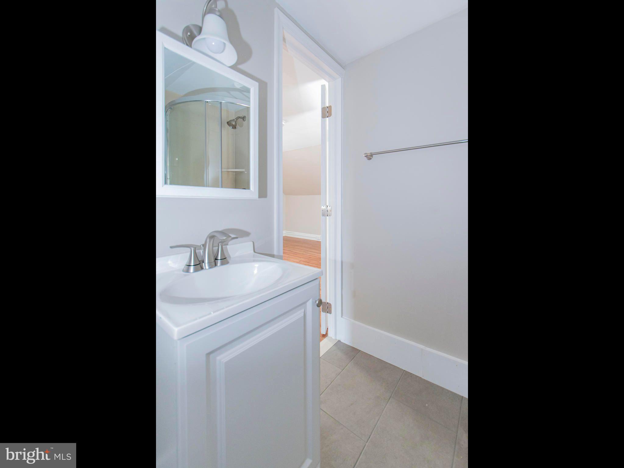 14 West 3rd Street, Unit 2 Pottstown, PA 19464 - Photo 10 of 13 a bathroom with a sink and a mirror