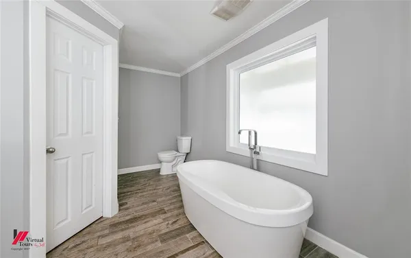 a white toilet sitting next to a bathroom sink