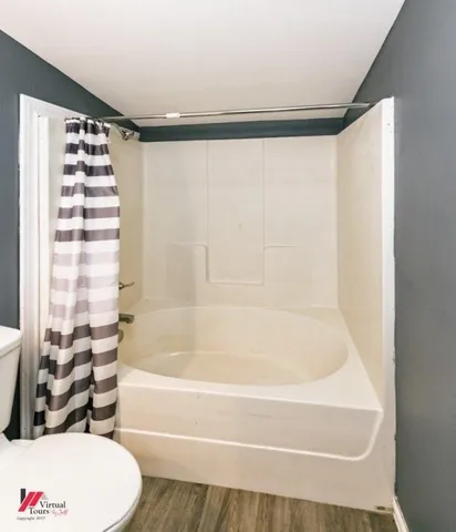 a view of a field with trees in the background