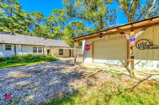 a backyard of a house with table and chairs