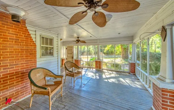 a living room with couches a dining table and chairs with wooden floor