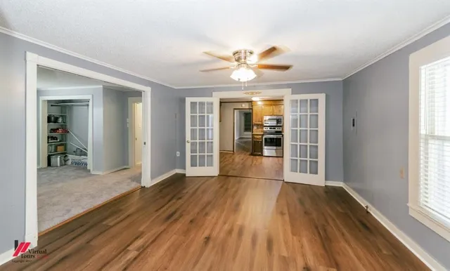 wooden floor in an empty room with a window