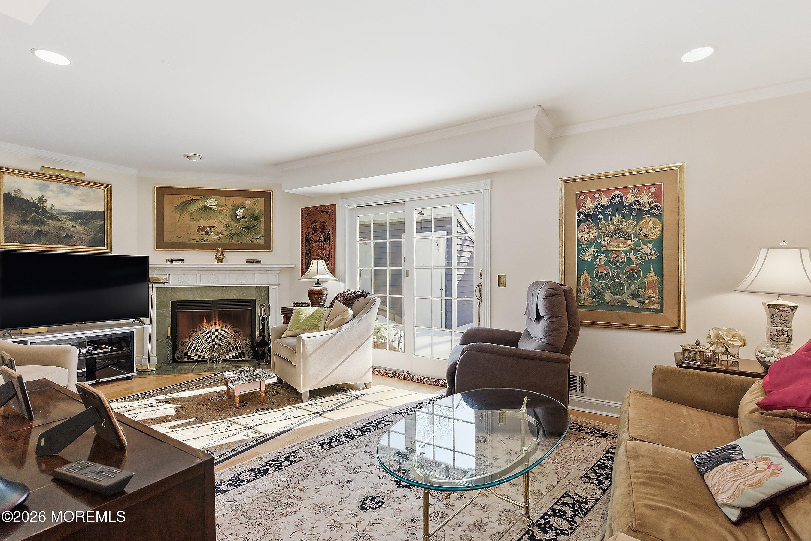 29 Rambling Meadow Court Tinton Falls, NJ 07724 - Photo 15 of 29 a living room with furniture a flat screen tv and a fireplace