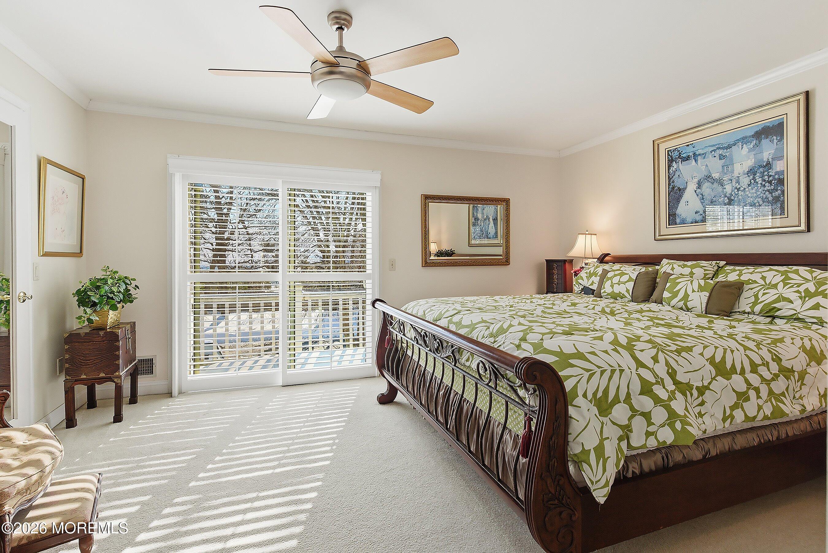 29 Rambling Meadow Court Tinton Falls, NJ 07724 - Photo 23 of 29 a bedroom with a large bed and a chandelier