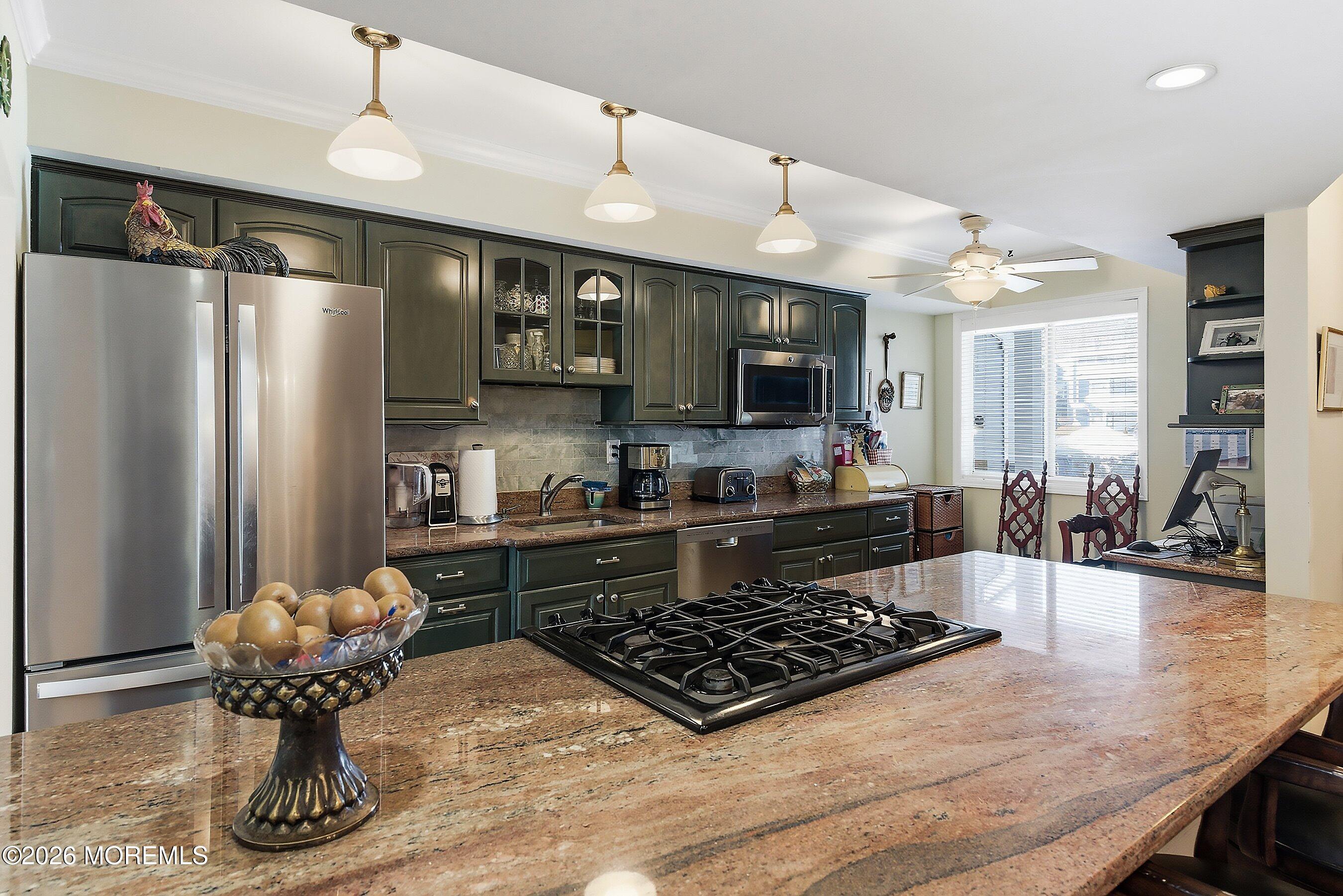 29 Rambling Meadow Court Tinton Falls, NJ 07724 - Photo 7 of 29 a kitchen with stainless steel appliances granite countertop a stove refrigerator and cabinets