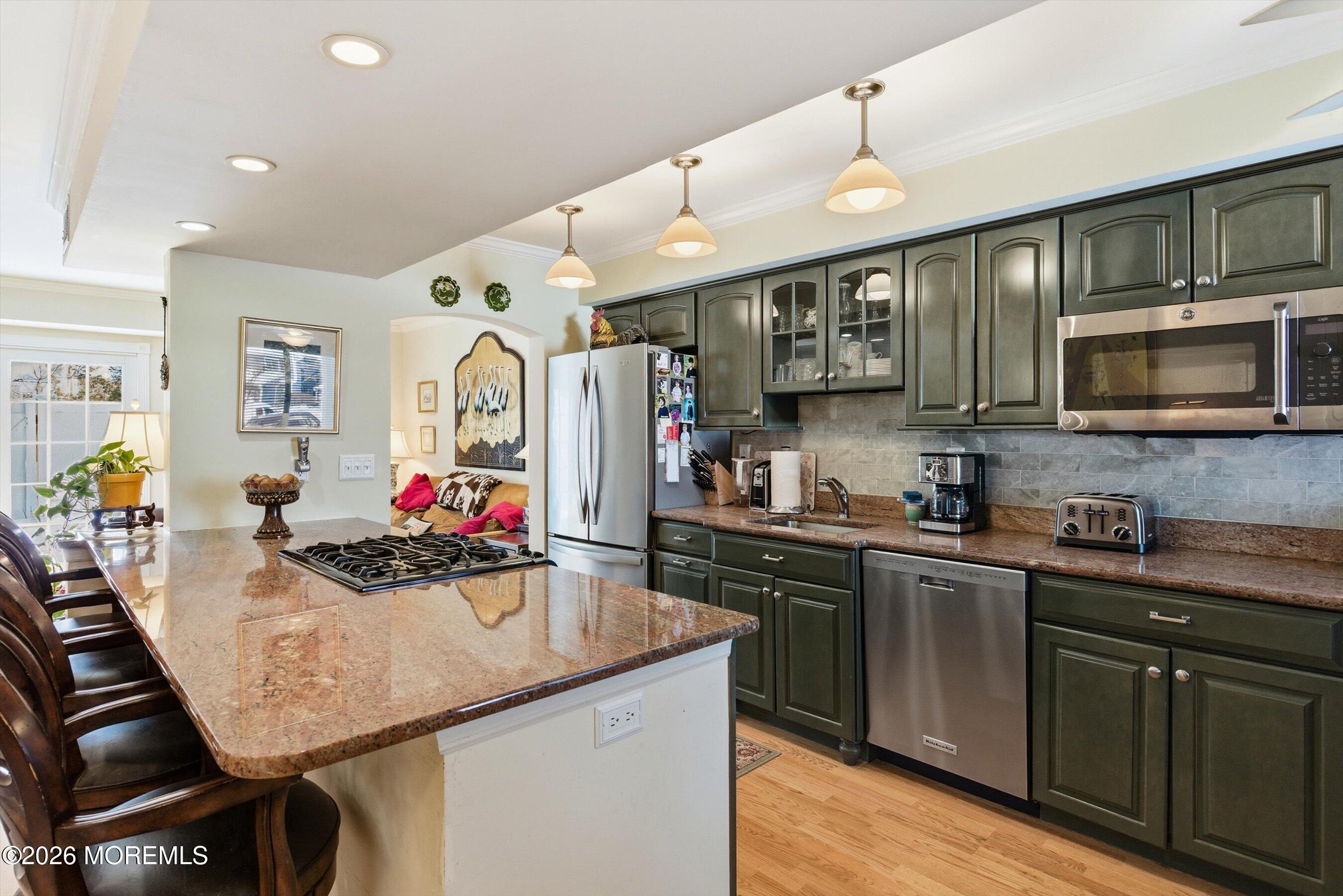 29 Rambling Meadow Court Tinton Falls, NJ 07724 - Photo 8 of 29 a kitchen with stainless steel appliances granite countertop a sink dishwasher a stove top oven a refrigerator with island and chairs