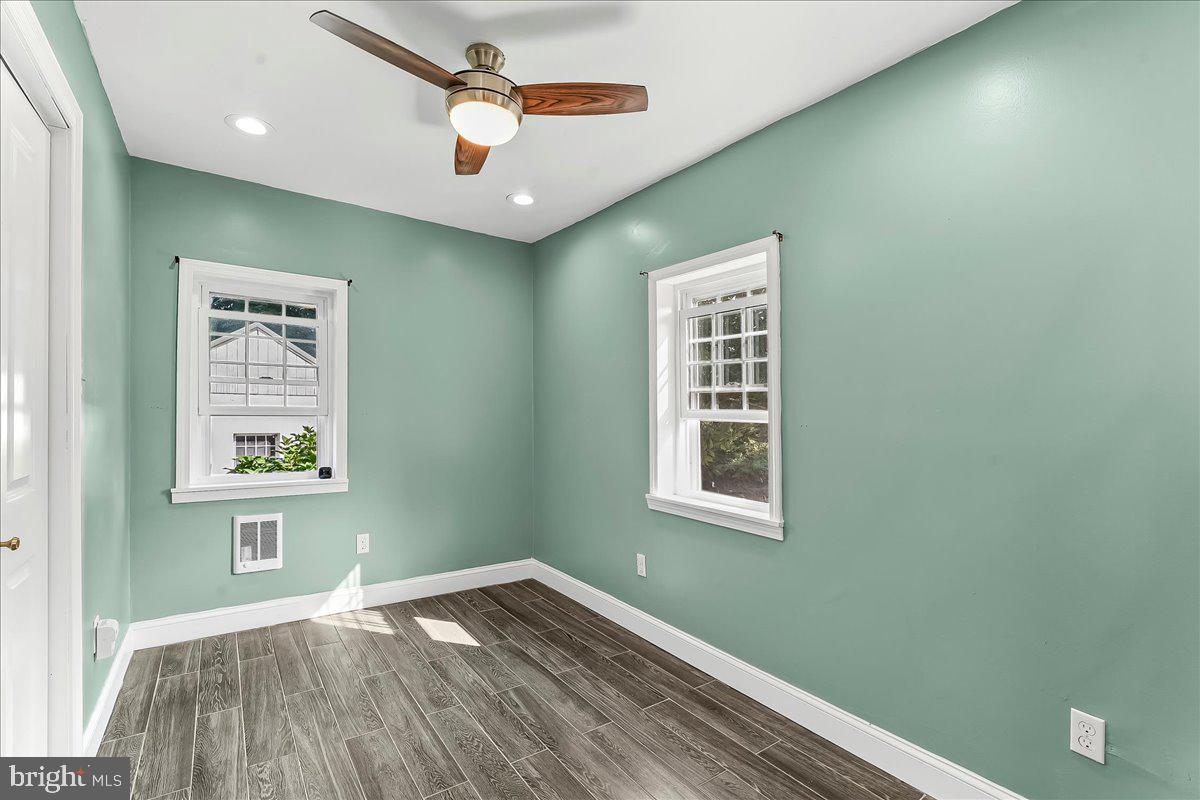990 Chesterville Road Oxford, PA 19363 - Photo 18 of 47 a view of an empty room with window and wooden floor
