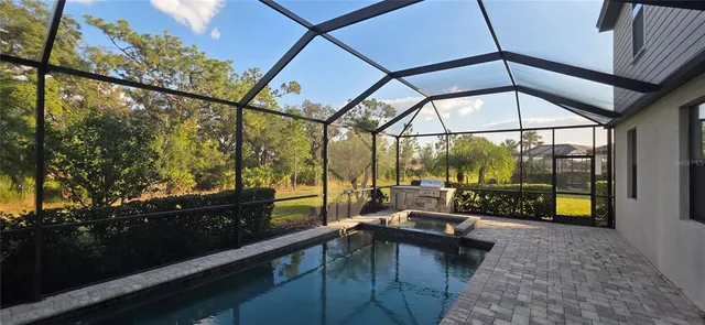 a swimming pool with outdoor seating and yard