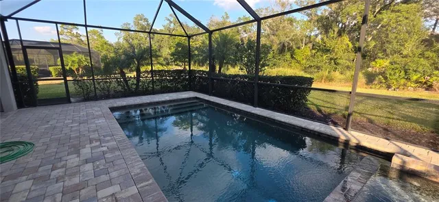 a view of a balcony with floor to ceiling windows and wooden fence