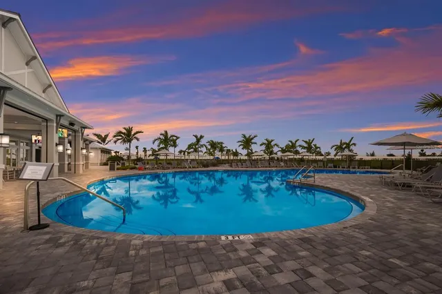 an aerial view of a pool patio swimming pool and ocean view