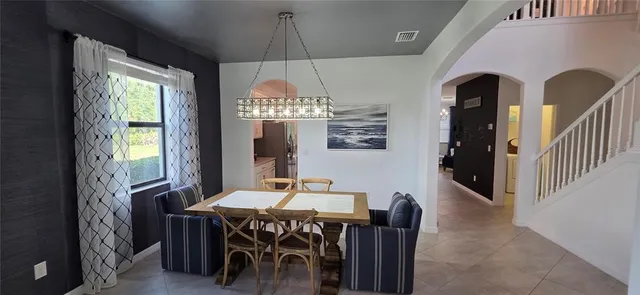 a view of a dining room with furniture window and outside view