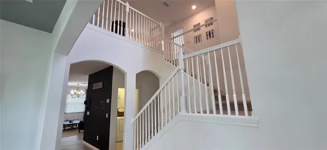 a view of staircase with white walls and a window